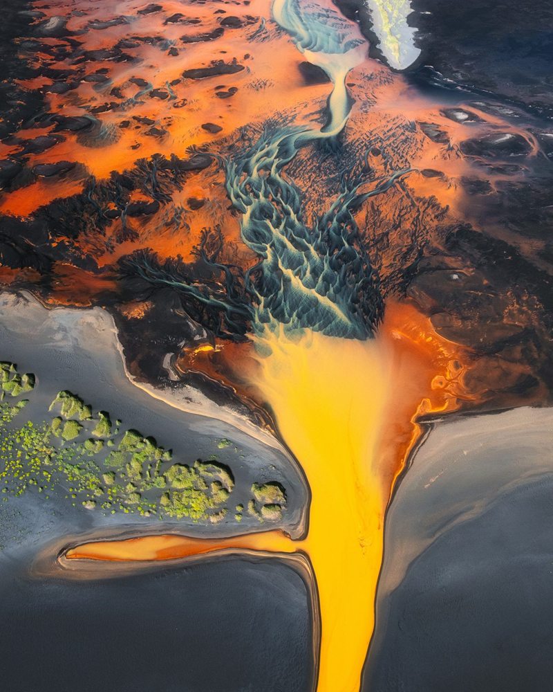 An orange glacial river from the air